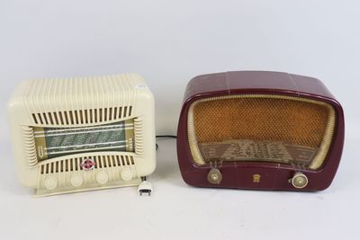 two old fashioned radio ' s sitting side by side on a white surface
