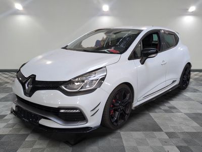 a white car is parked in a room with a checkered floor