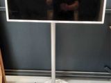 a man taking a picture of a flat screen tv