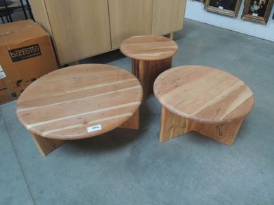 three wooden tables and two stools sitting in a room