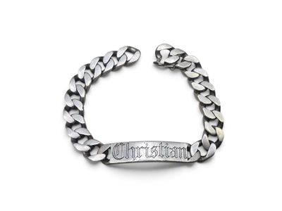 a close up of a silver bracelet with a chain on a white background