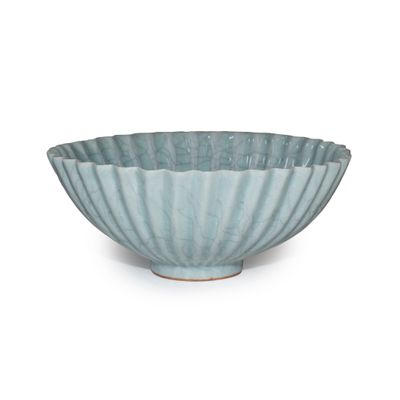 blue and white ceramic bowl with wavy design on a white background