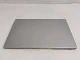 a silver laptop on a white surface with a white background