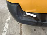 a close up of the front bumper of a yellow car