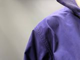 a close up of a person wearing a purple jacket