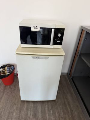 a microwave that is sitting on top of a refrigerator
