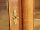 a close up of a door handle on a wooden door