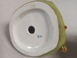 a close up of a white plate with a green apple on it