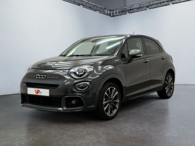 a grey fiat car parked in a large room with a white wall