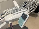 a chair that has a monitor on it in a room