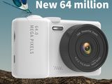 a white camera sitting on a tree branch with a butterfly on top of it