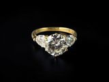 a yellow gold engagement ring with three pear shaped diamonds