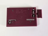 a close up of a red electronic device on a white surface
