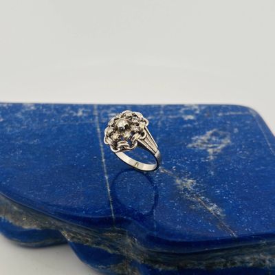 a close up of a blue stone with a silver ring on it