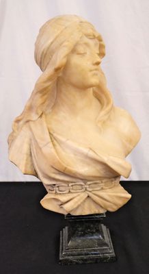 marble bust of a woman wearing a turban on a black table