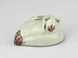porcelain figurine of a sleeping giraffe on a white surface