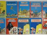 six livres en français et en anglais posés sur une surface blanche