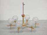 a chandelier made of glass and gold metal