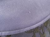 a close up of a purple and green bag with a flower design