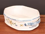 a white bowl with blue and yellow designs on it
