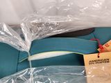 a blue suitcase that is wrapped in plastic and sitting on the floor