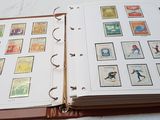 an open book with stamps on it sitting on a bed