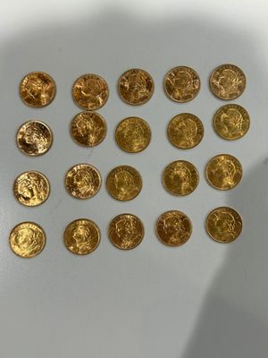 a lot of gold coins sitting on a white surface
