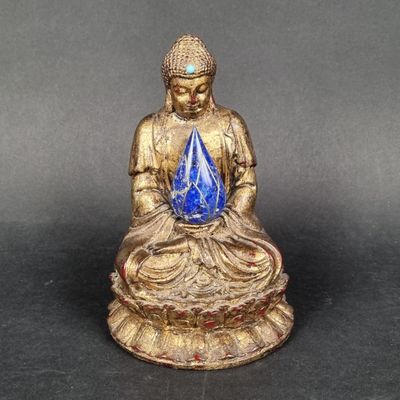 an image of a statue of a person sitting on a lotus