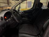 the interior of a small car with a steering wheel and dashboard