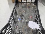 a basket full of empty wine glasses on the floor