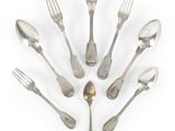 a lot of silver spoons and forks arranged in a circle