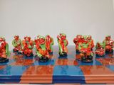 many figurines of zombies on a chess board