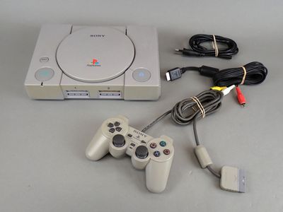 a video game console and a game controller on a table