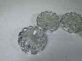 three clear glass coasters sitting on top of a white table