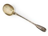 an antique silver spoon with a spoon handle on a white surface