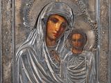 a metal plaque with an image of the virgin and child