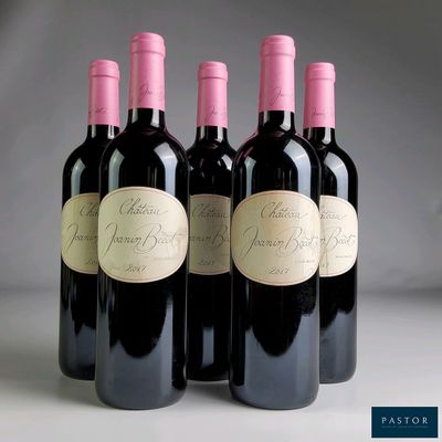 four bottles of wine are lined up in a row on a table