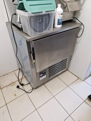 an image of a kitchen with a sink and a freezer
