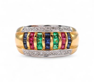 a close up of a gold ring with multi colored stones