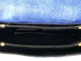 a blue purse sitting on top of a white table