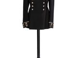 a black military jacket with gold buttons on a mannequin stand