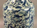 a blue and white vase with a bird design on it