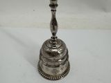 a silver plated candle holder on a white surface
