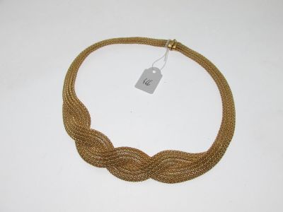a close up of a gold necklace with a tag on it