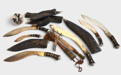 many different types of knives and knives on the table