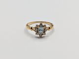 a close up of a gold ring with a blue topaz stone