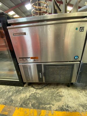 a stainless steel refrigerator in the middle of a room