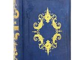 an old blue book with a gold design on the cover