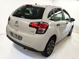 a white car that is parked in a white room