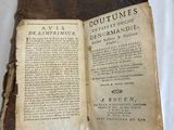an old book that is open on a white surface